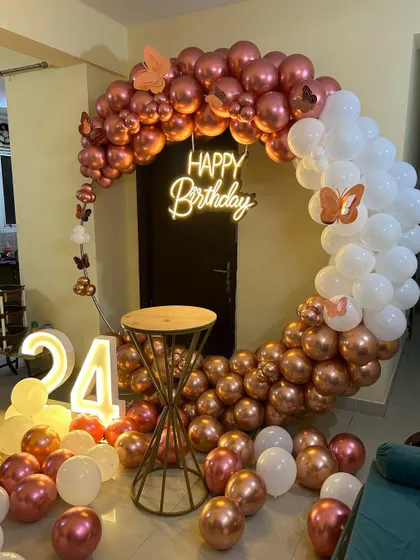 This is a duplicate of ID 10, 57, 76, 120, 210. An elegant and modern ring backdrop is perfect for home celebrations. The setup features a circular frame with a rose gold and white chrome balloon arrangement, a 'Happy Birthday' neon sign, and a light-up marquee number '24'.