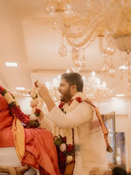 A fun and traditional ritual where the bride and groom are lifted up by their families for the varmala exchange, filled with laughter.