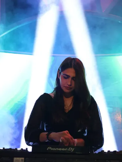 A clear, focused shot of me at the decks under a spotlight at Molecule Meerut. This highlights the professionalism and concentration I bring to every performance.