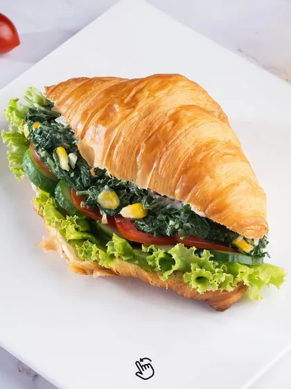 A healthy and delicious Spinach and Corn Croissant Sandwich. This vegetarian option is filled with a creamy mixture of spinach and sweet corn, making for a light yet satisfying bite.