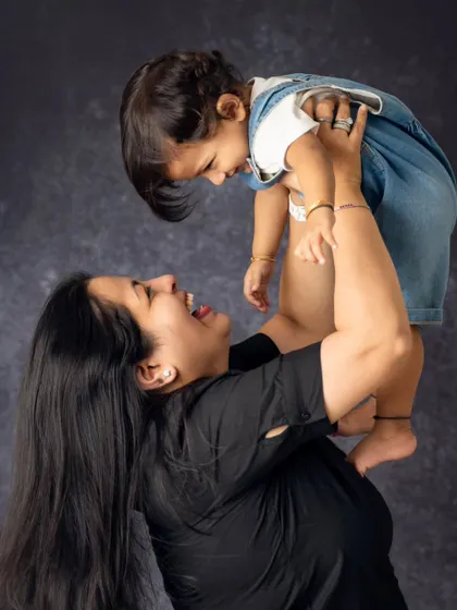 Our family sessions are all about fun and movement. We encourage playfulness to capture the pure joy and energy of childhood, resulting in candid shots like this one that are bursting with laughter and personality.