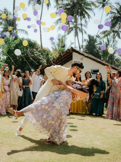 A beautiful, dynamic shot of the couple dancing, with guests releasing balloons in the background. It’s a moment of pure celebration.