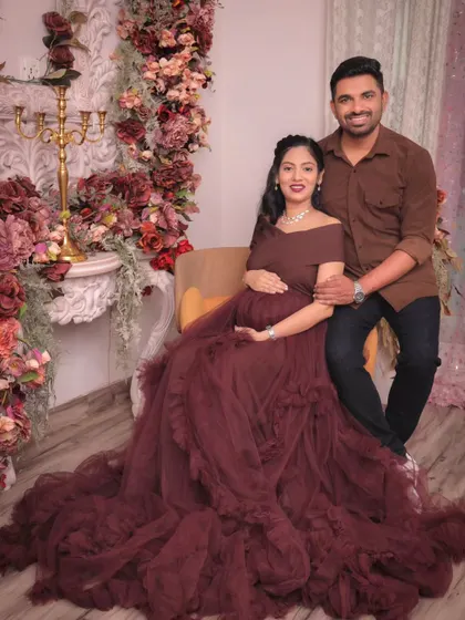 A relaxed, seated portrait of the couple. The combination of the elegant gown and casual shirt creates a balanced and modern look.