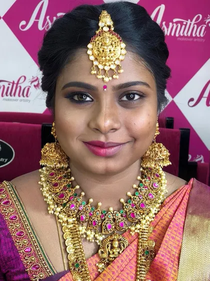 A close-up of a traditional bridal look created during a student demonstration, highlighting the classic features of South Indian bridal makeup.