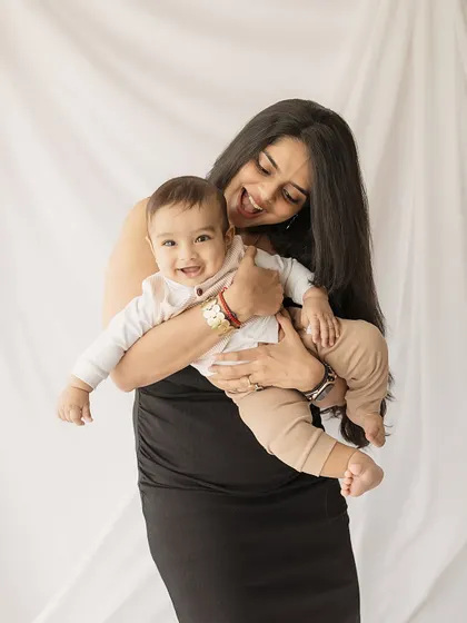 A mother's playful embrace. Her expression of delight as she holds her baby is what makes these photos so full of life and love.