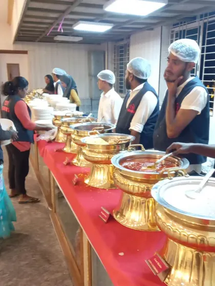 Our staff stands ready at a fully arranged buffet line at SSR Function Hall. We use traditional golden serving dishes to add a touch of class to the wedding feast, ensuring food is kept warm and served professionally.