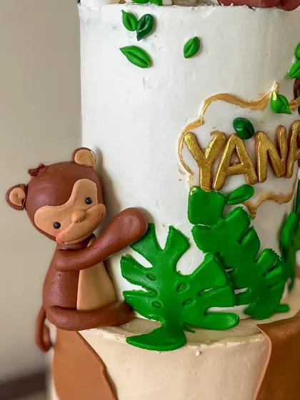 A close-up of the cute fondant monkey climbing the side of the cake.