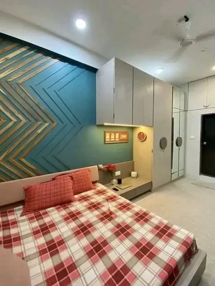 A different angle of the bedroom, showcasing the wardrobe and the custom wooden art on the wall. This design is perfect for optimizing space in smaller rooms.