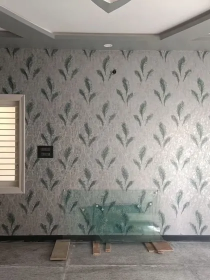 A bedroom with a grey feather pattern wallpaper, creating a calm and serene environment.