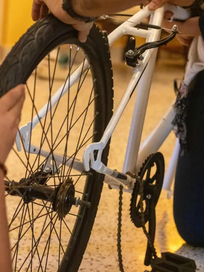 Students work on the rear wheel and gear cassette of a bicycle. This is a great hands-on lesson in mechanical engineering.