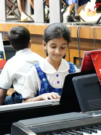 A young student at her keyboard during the Annual Recital at CSN School, Pune. Our in-school programs culminate in these wonderful recitals, showcasing the progress students have made throughout the year.