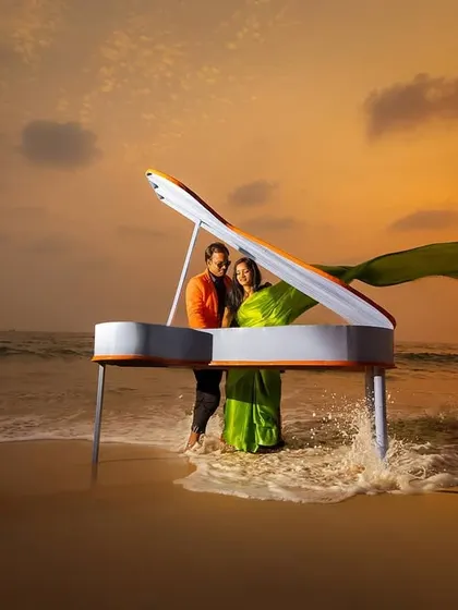 A grand piano on the beach at sunset. We believe in creating surreal and unforgettable concepts for your save the date or pre-wedding shoot, making your announcement truly stand out.