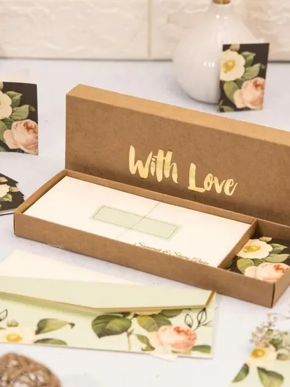 Personalized stationery makes for a timeless and elegant wedding favor. This set includes custom floral-themed envelopes, note cards, and gift tags, all presented in a beautiful box with "With Love" embossed in gold foil.