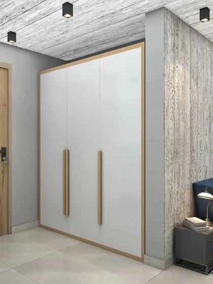 A simple yet elegant white wardrobe with natural wood handles complements the minimalist aesthetic of the bedroom.