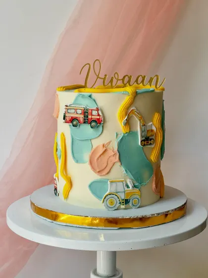 An abstract construction-themed cake. I used painted buttercream patches and small fondant vehicles to create a modern and artistic take on the theme.