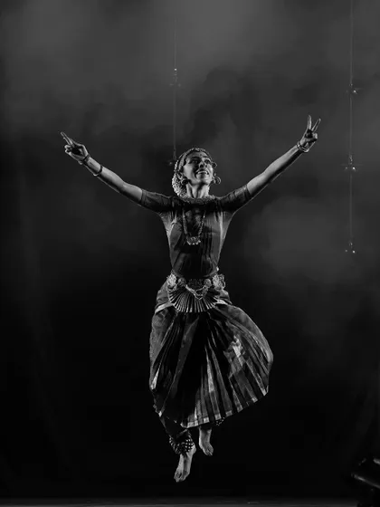 A leap of joy, celebrating the divine love of Krishna. This black and white photograph freezes a moment of pure, uninhibited bliss.