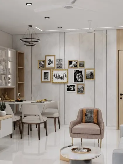 This angle shows the TV unit and a gallery wall for personal photos, making the house feel like a home. The layout seamlessly integrates the dining and living areas for maximum functionality.