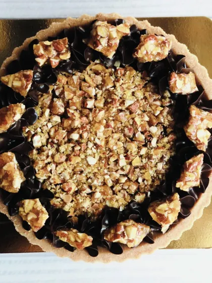 This overhead shot captures the beautiful contrast between the dark, silky chocolate and the golden, crunchy almond topping.