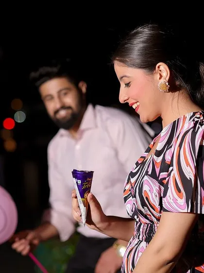 A fun, candid shot capturing a sweet moment with a chocolate and a smiley balloon, showing that even in the grandest locations, it's the small, personal touches that matter.