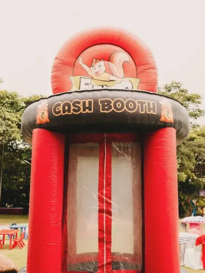 An inflatable cash booth where kids could try to grab flying "money." This interactive game was a huge hit and perfectly matched the Monopoly theme.