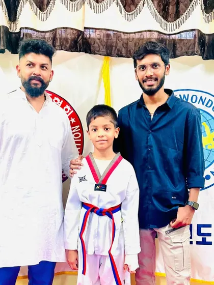 A young student with his new red and blue belt.