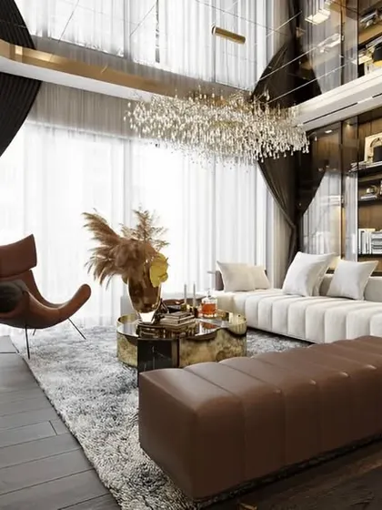 This ultra-luxurious living room features a high ceiling with a mirrored surface, creating a sense of grandeur. A stunning crystal chandelier and a built-in aquarium add unique, high-end touches to the design.