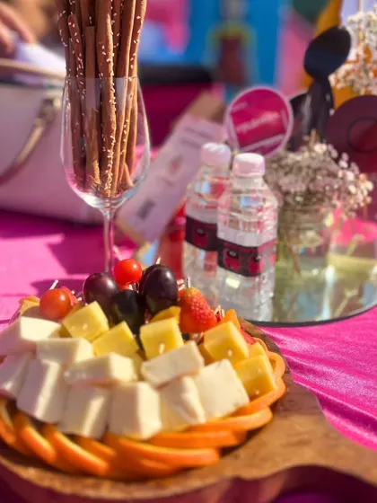 Part of our Squid Game themed party, this cheese and fruit platter on a rustic wooden board shows how we can integrate classic offerings into any creative event theme.