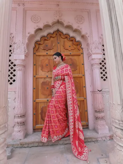 A thoughtful pose in front of the door, with the model looking down. This creates a quiet and introspective mood.