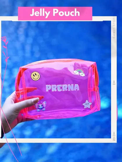 A hand holding a personalized neon pink jelly pouch against a water background. Customized with a name and cute patches, it's a perfect summer accessory or party favor.