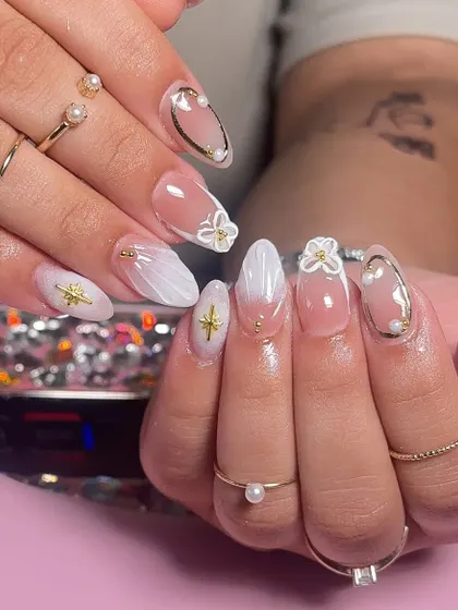 Nails that speak louder than words. A beautiful white ombre set with seashell textures and 3D floral details, perfect for a summer holiday.