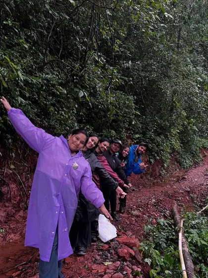 A fun "train" of trekkers posing on a muddy trail in Kodachadri.