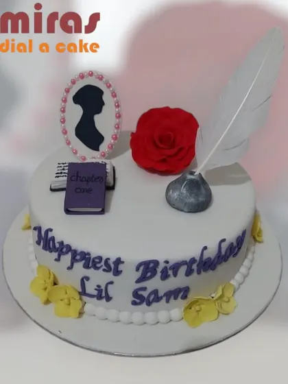 A literary cake for a Jane Austen fan. This elegant design features a silhouette cameo, a quill and inkpot, and a tiny book, celebrating the classic author in a sweet way.