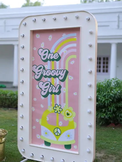 Another angle of the "One Groovy Girl" marquee sign, showing its bright lights and playful 70s-inspired graphics.