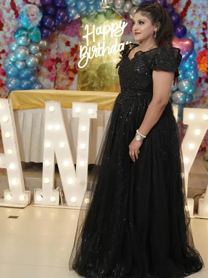 A confident pose from our client, looking gorgeous in our black party gown.