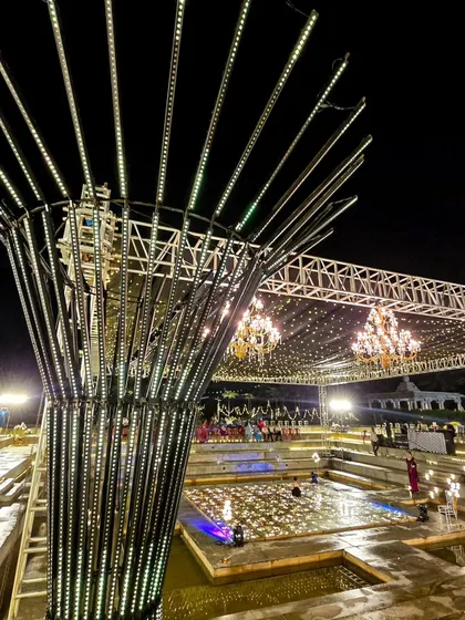 A large-scale sangeet setup in an amphitheater-style venue, showcasing our expertise in managing complex lighting rigs and production.