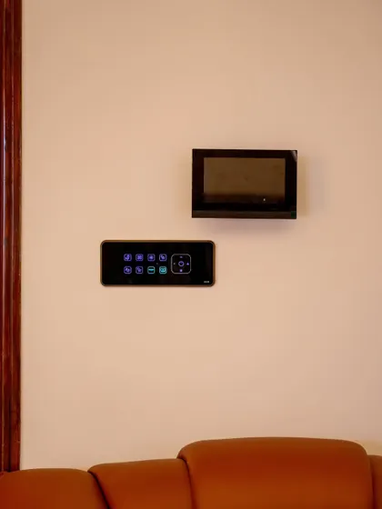 A smart panel and video monitor installed on a plain wall, ready to provide centralized control for the entire home.