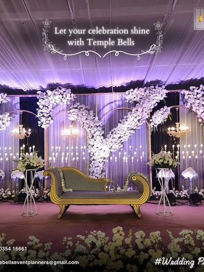 A sophisticated and modern reception stage design. We used a color palette of white and lavender, with cascading floral arrangements, elegant chandeliers, and soft backlighting to create a dreamy, romantic ambiance.