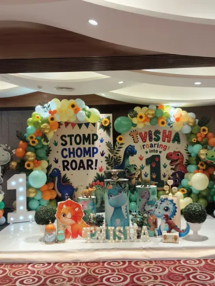 We can transform any venue into a different world. For this first birthday, we designed a complete dinosaur theme, including a custom backdrop, balloon decorations, and adorable character props for the perfect photo opportunity.