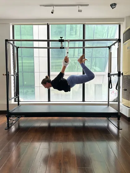 Flying in the air. This suspended pose on the Cadillac builds core stability and a feeling of weightlessness and control.