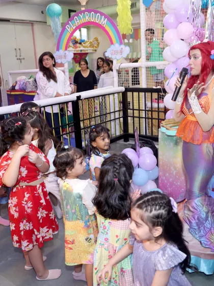 The look of pure wonder on a child's face is what we live for. Here, a group of young guests are completely captivated as they meet and interact with our beautiful mermaid character during a themed party.
