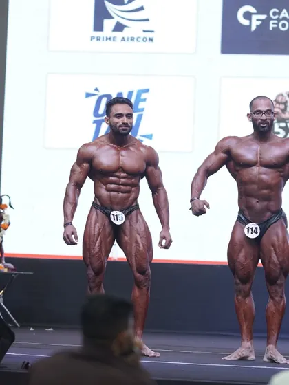 Front relaxed pose, showing the v-taper and abdominal definition. This is a foundational pose in any bodybuilding competition.