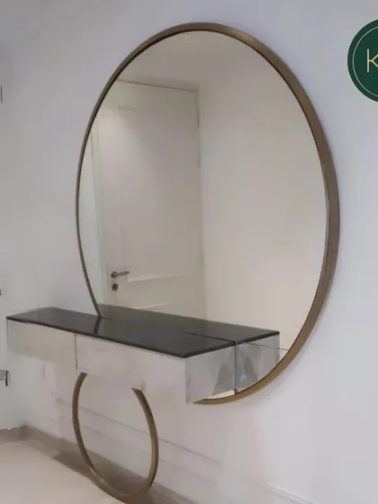 A bespoke dressing area is a personal luxury. We designed this floating console and oversized circular mirror for the prestigious Paras Quartier collection, combining minimalist form with a striking gold-finished frame to create a functional and glamorous vanity space.
