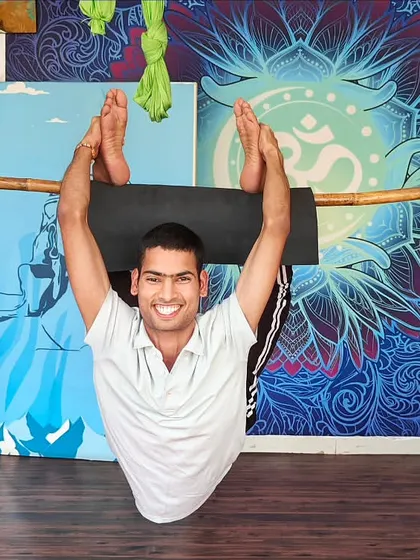 We creatively use props like this bamboo stick to help students safely explore advanced backbends. This method provides support while building the core strength and spinal flexibility needed for challenging asanas, making them accessible to more practitioners.