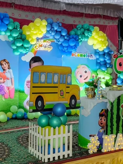 A complete stage setup for a Cocomelon first birthday party, showing how I use the entire space to build the theme.