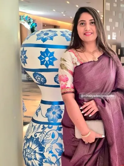 A lovely client in a purple silk saree. I designed a contrasting floral printed blouse to add a touch of modern charm to her traditional attire.