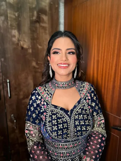 A beautiful, joyful portrait of Heer. The makeup was designed to complement the intricate embroidery of her navy blue outfit.