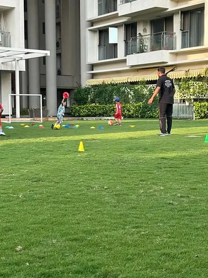 A young player aims for the goal during a toddler football session, building skills and having a blast.