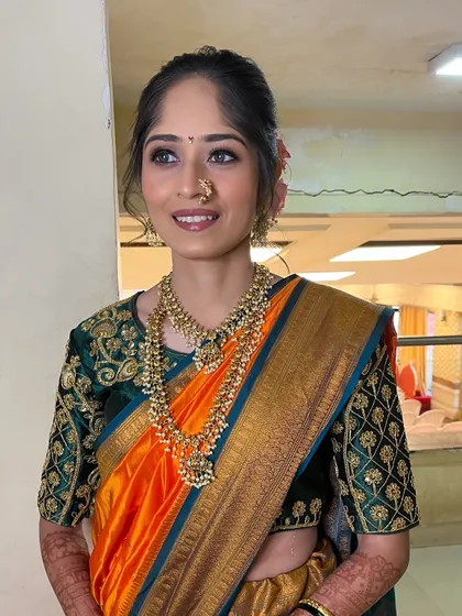 The full look, showing how the makeup, hair, and orange Paithani saree come together for a stunning traditional appearance.