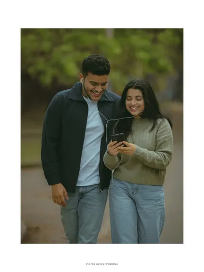 Walking and sharing a song, this candid moment from a pre-wedding shoot feels natural and full of easygoing love.