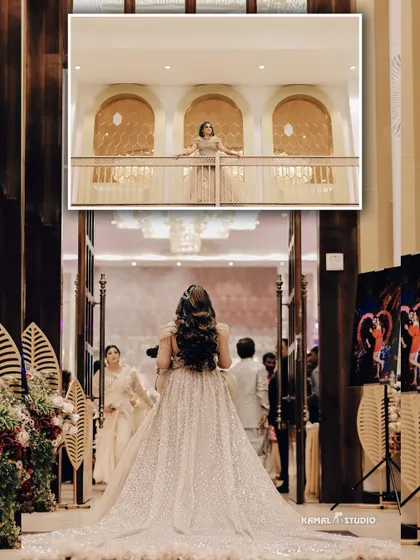 A dramatic shot of the bride's grand entrance, capturing her from behind as she walks towards the celebration.